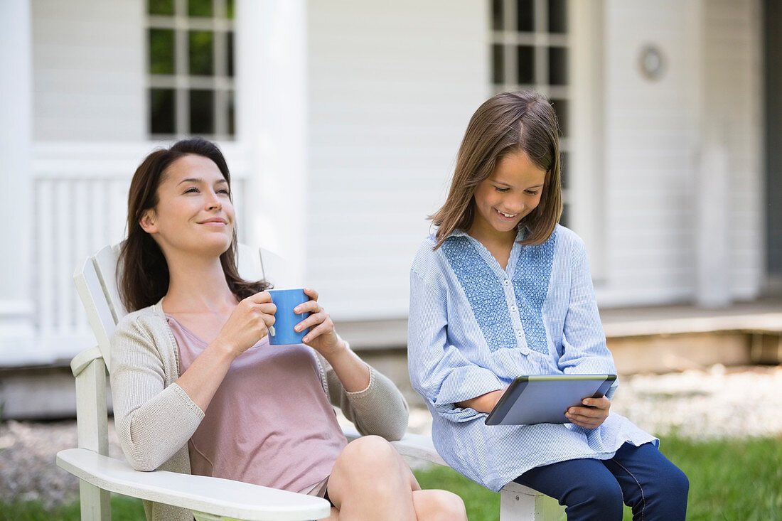 Mother and daughter relaxing outdoors