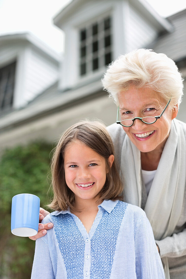 Woman and granddaughter smiling