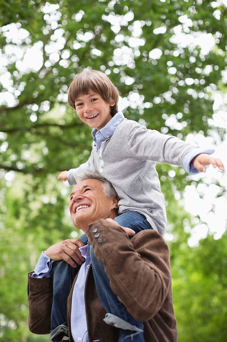 Man carrying grandson on shoulders