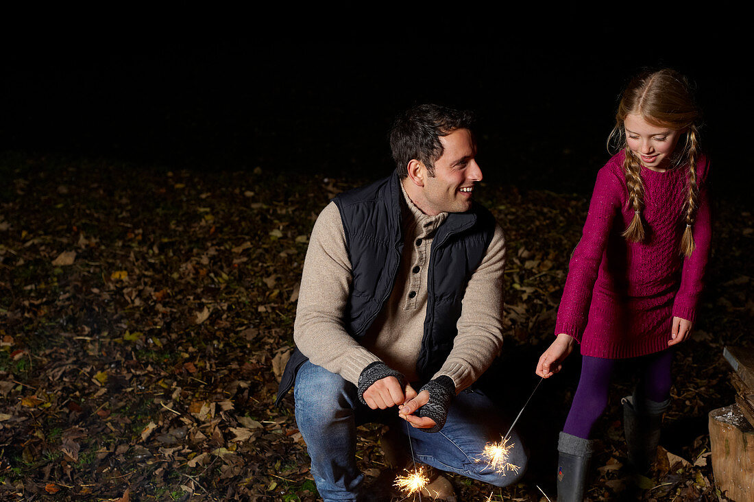 Father and daughter with sparklers