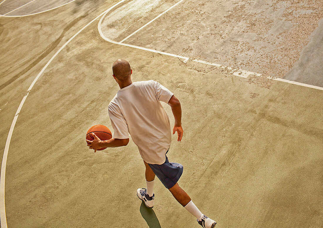 Man playing basketball on court