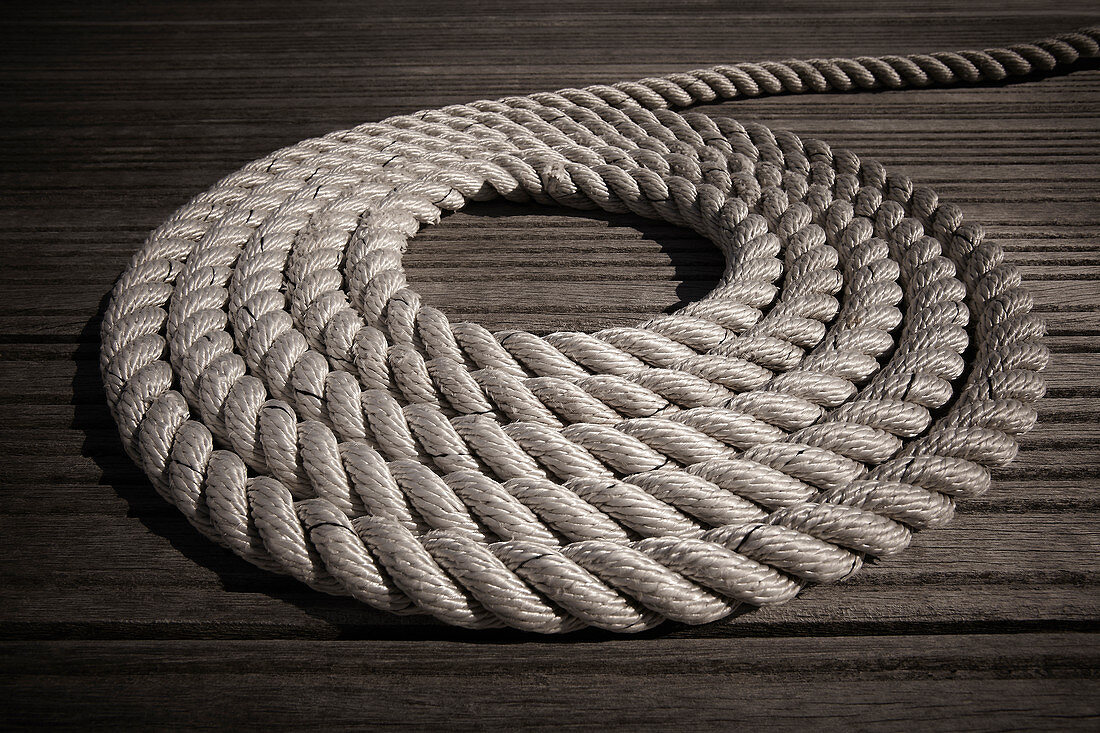 Rope coiled in circle on boardwalk