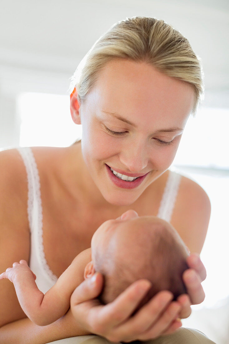 Mother cradling newborn baby