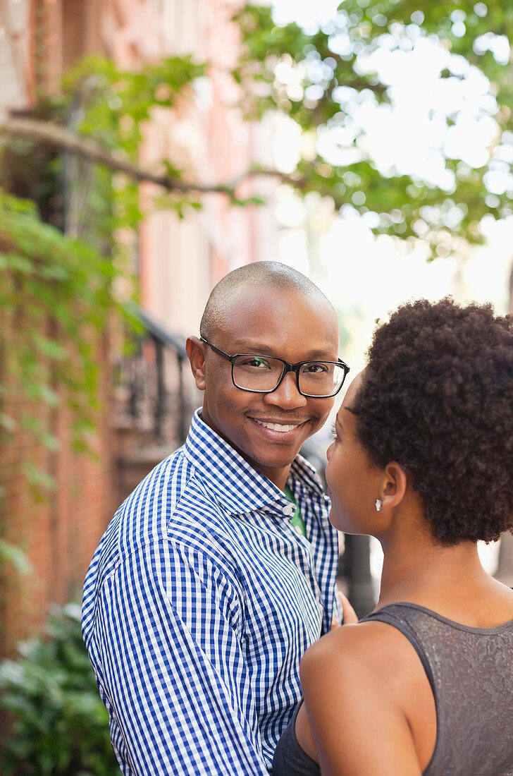 Couple hugging on city street