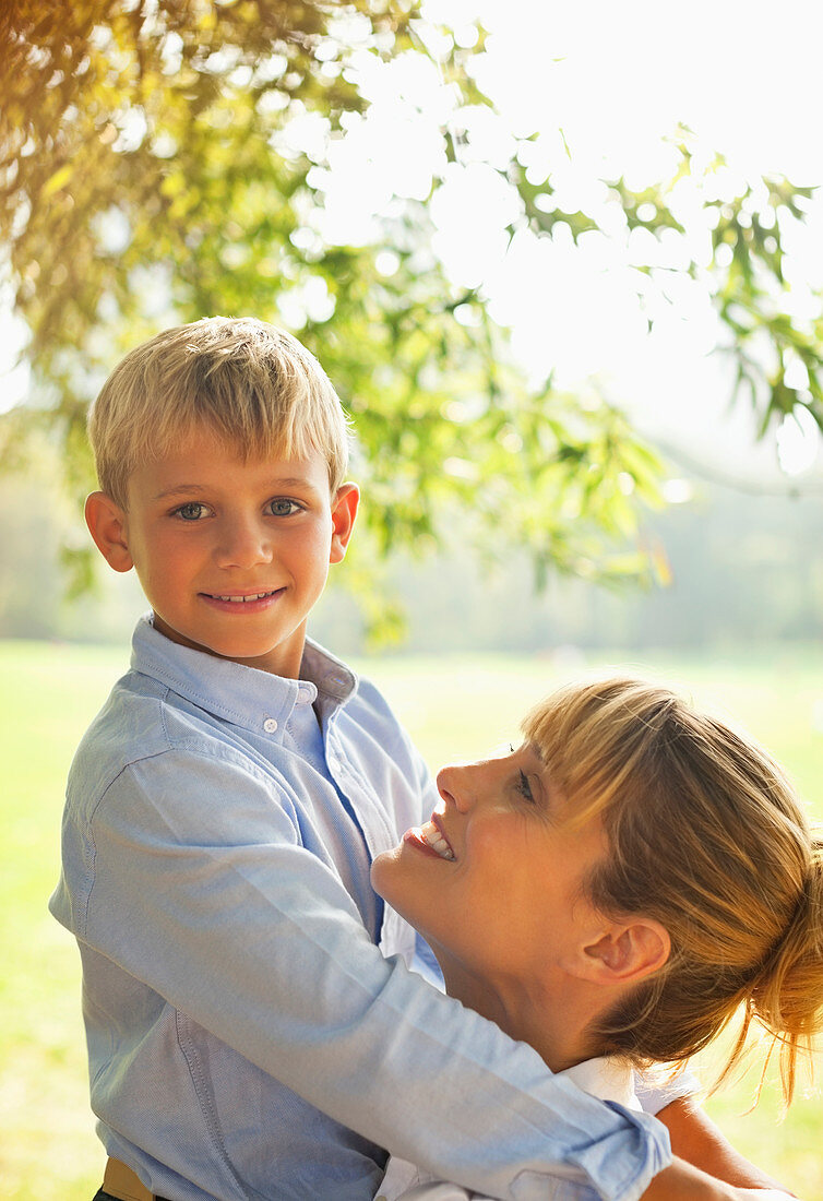 Mother and son hugging in park