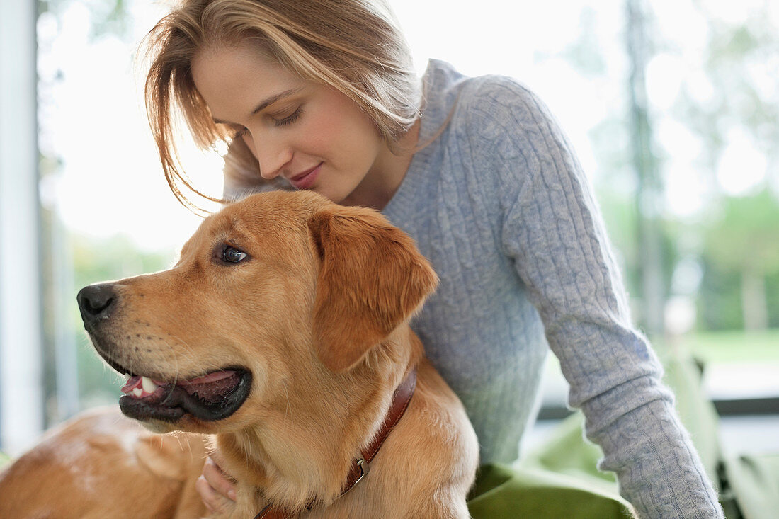 Woman relaxing with dog indoors