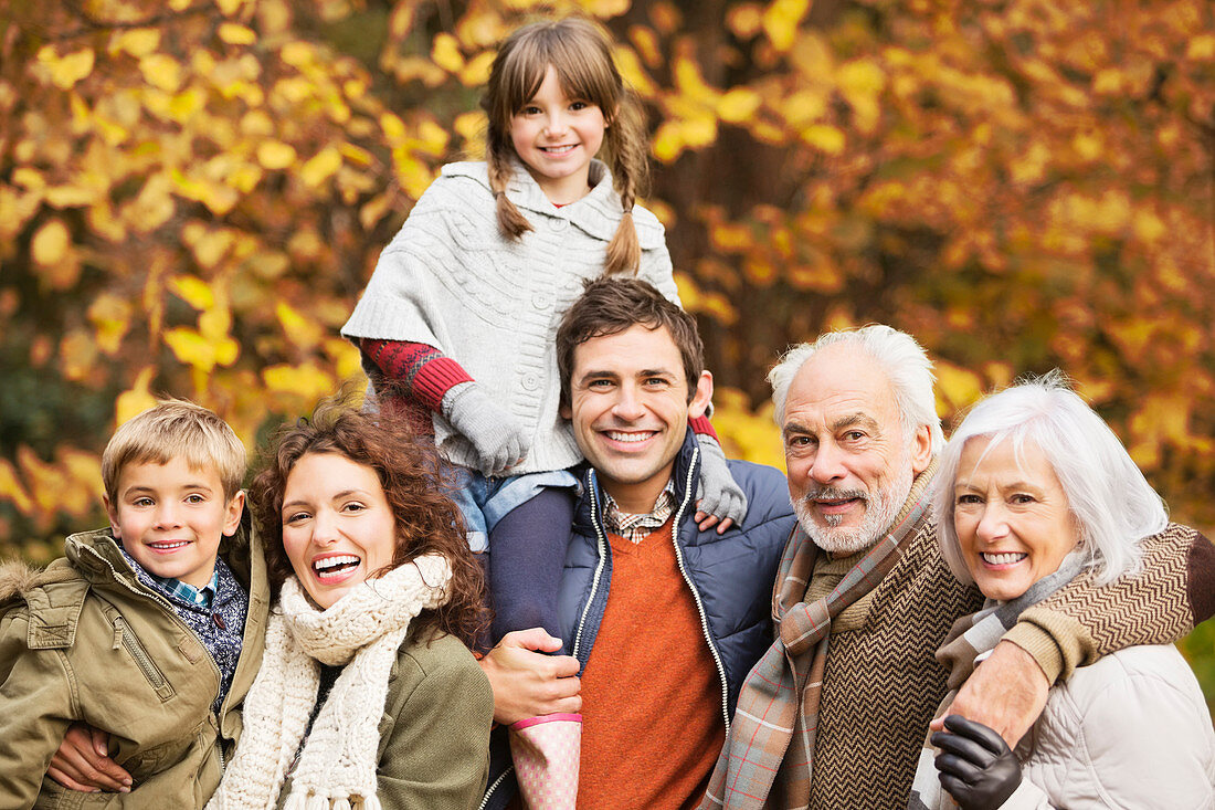 Family smiling together in park