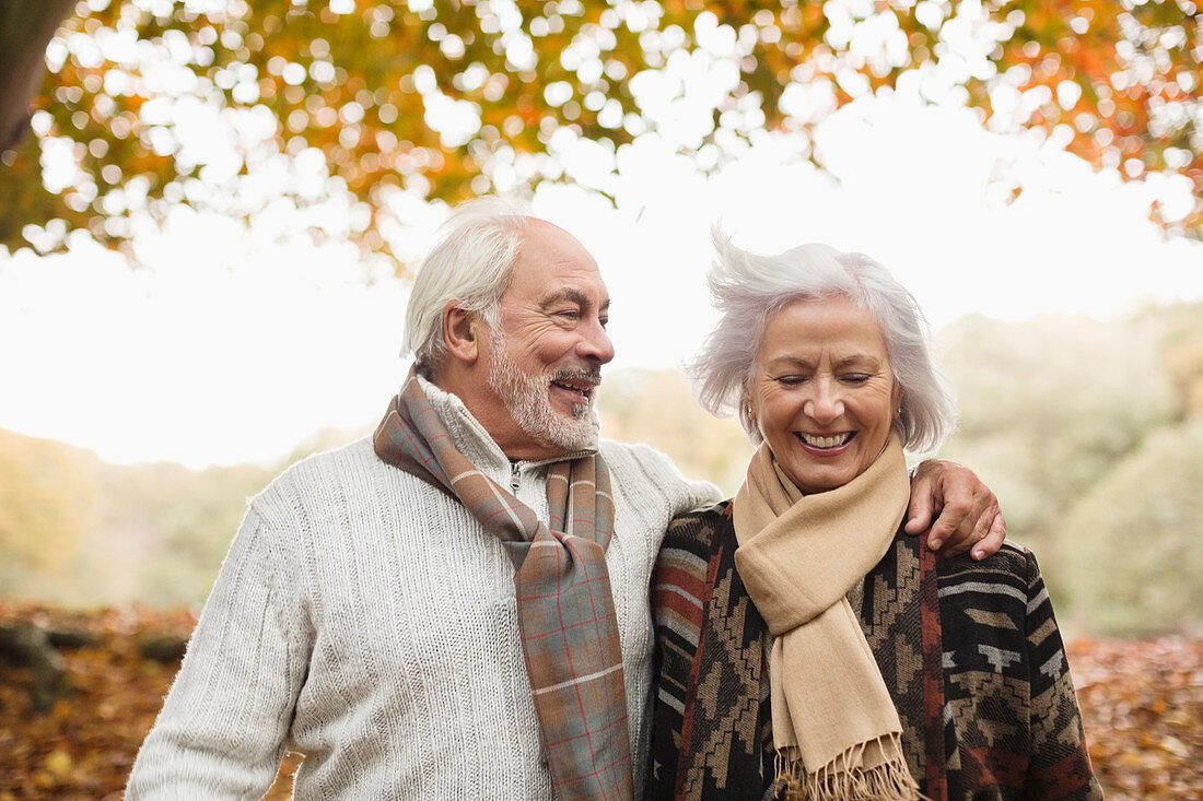 Older couple walking together in park