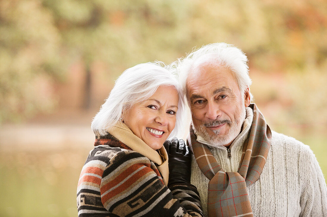 Older couple smiling together in park