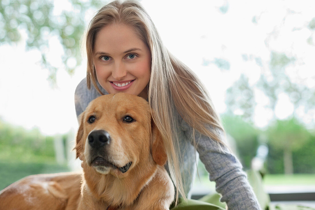 Woman relaxing with dog indoors