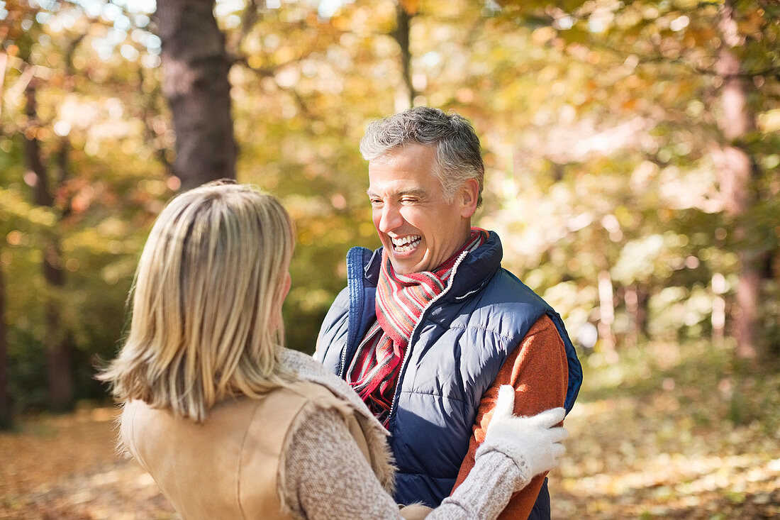 Older couple hugging in park