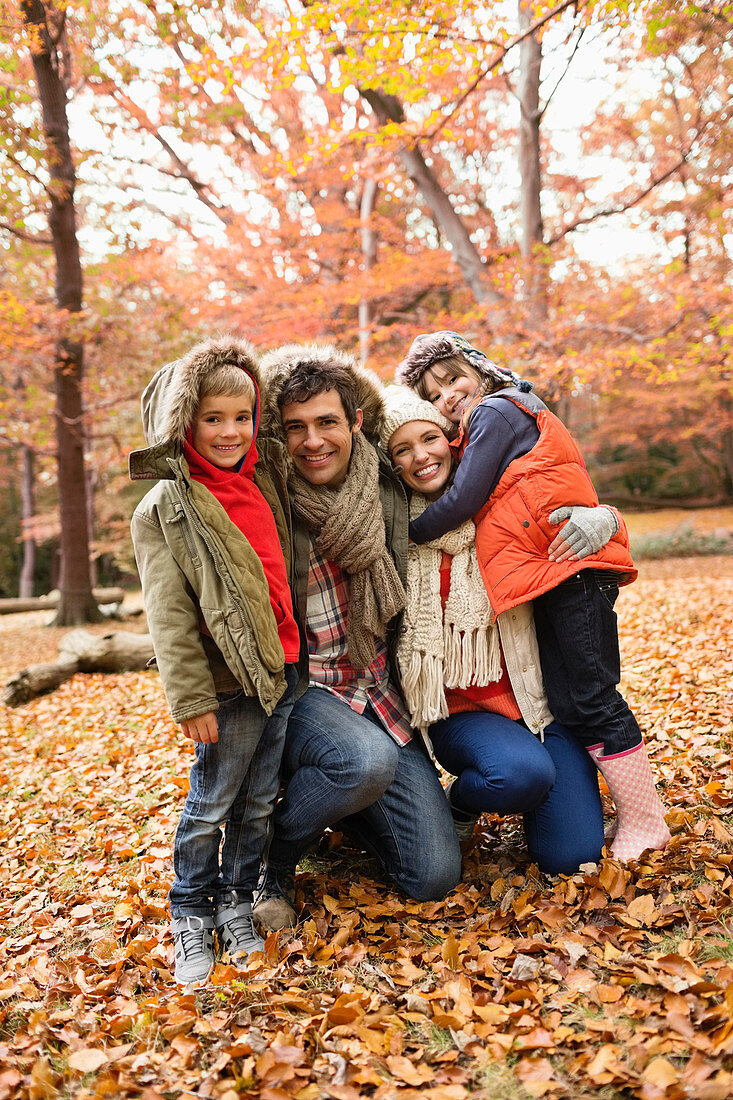 Family smiling together in park