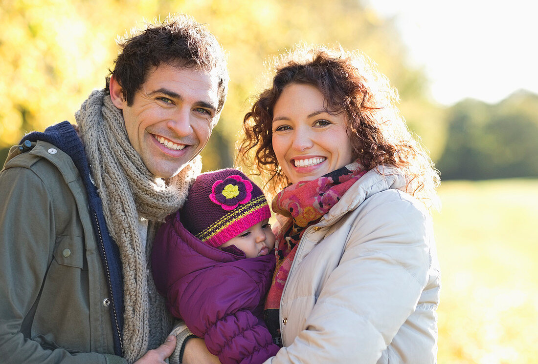 Family smiling together in park