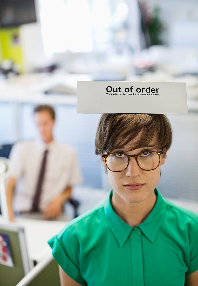 Businesswoman wearing out of order' sign