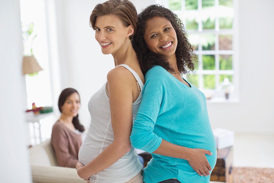 Pregnant women smiling together