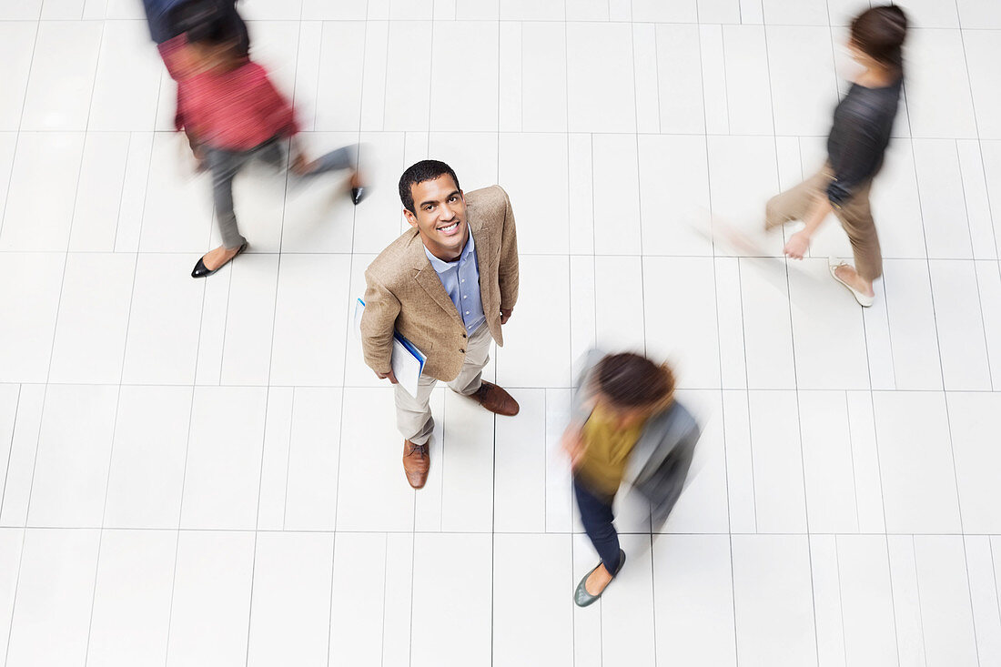 Businessman smiling in office hallway