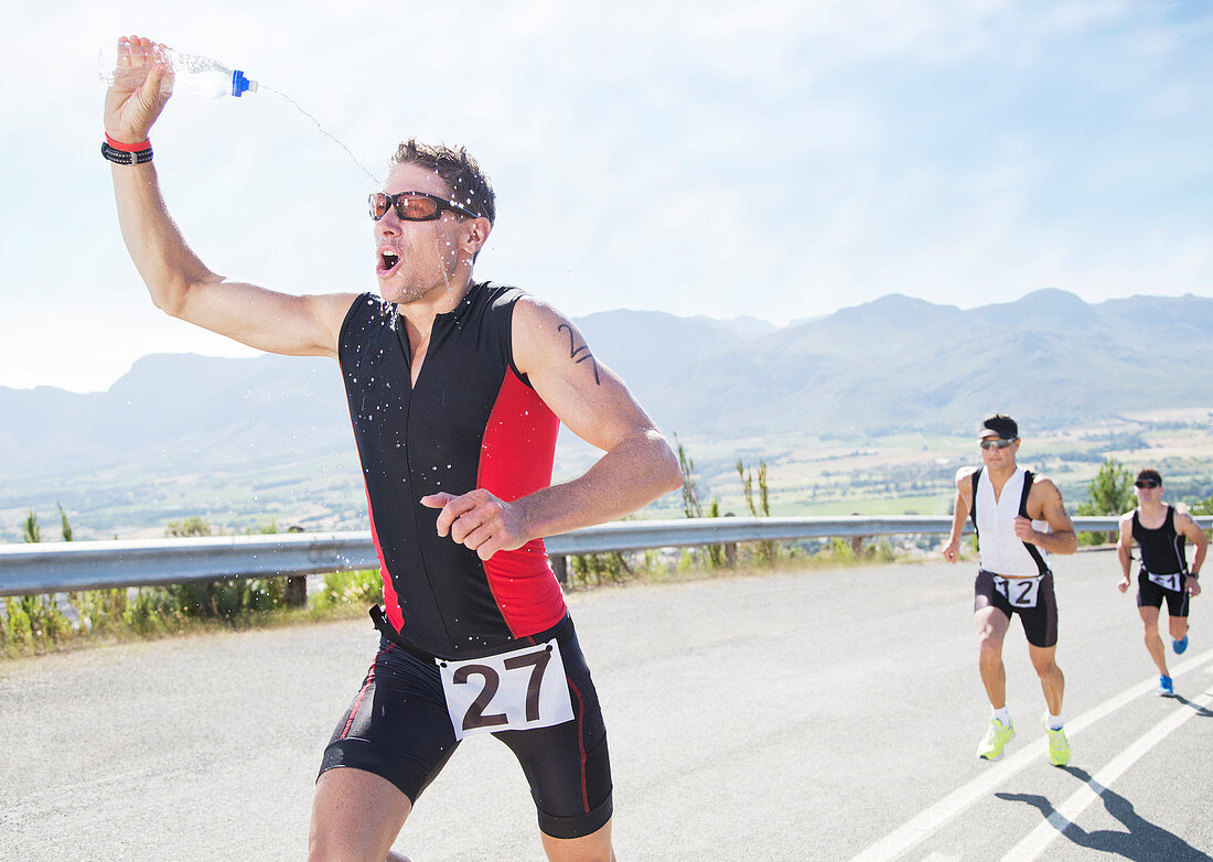 Runner spraying himself with water