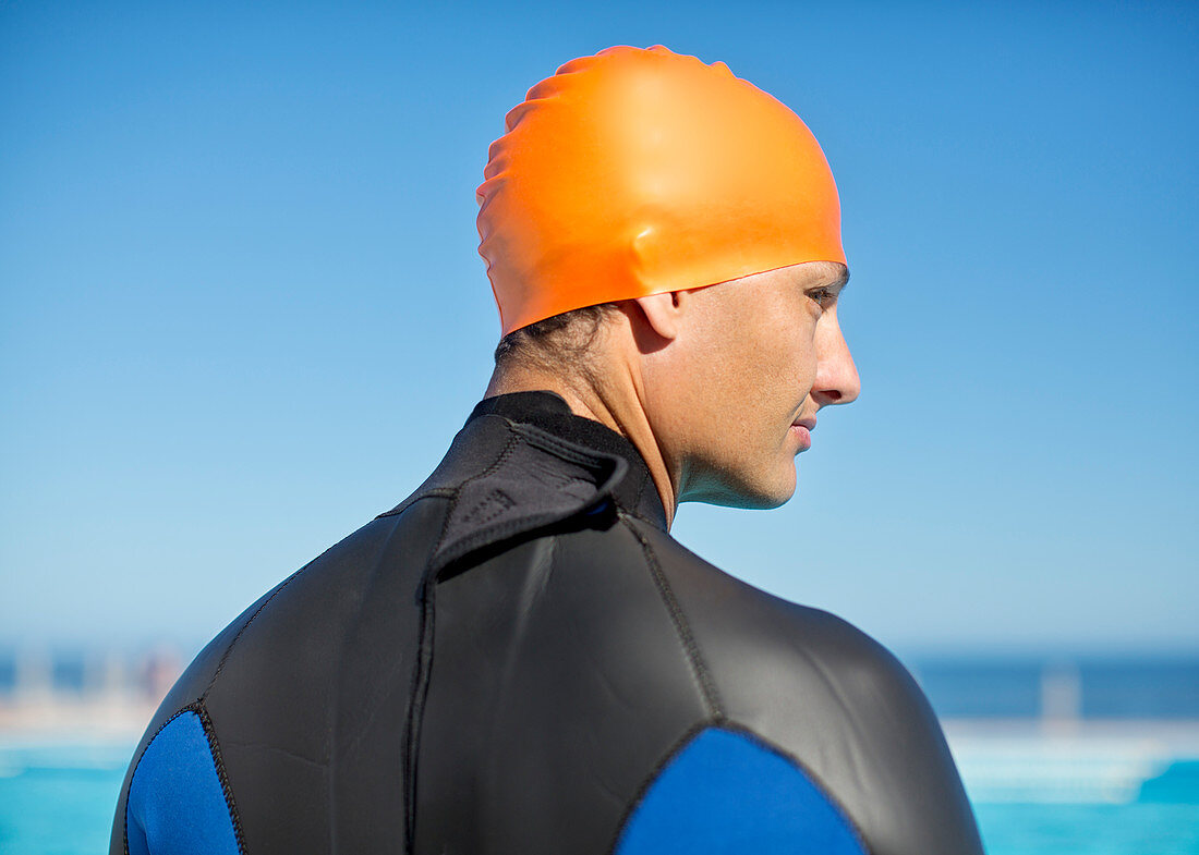 Triathlete wearing wetsuit and cap