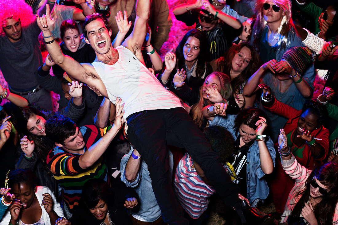 Man crowd surfing at music festival