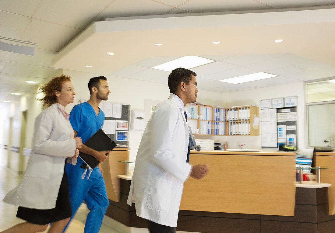 Hospital staff rushing down hallway