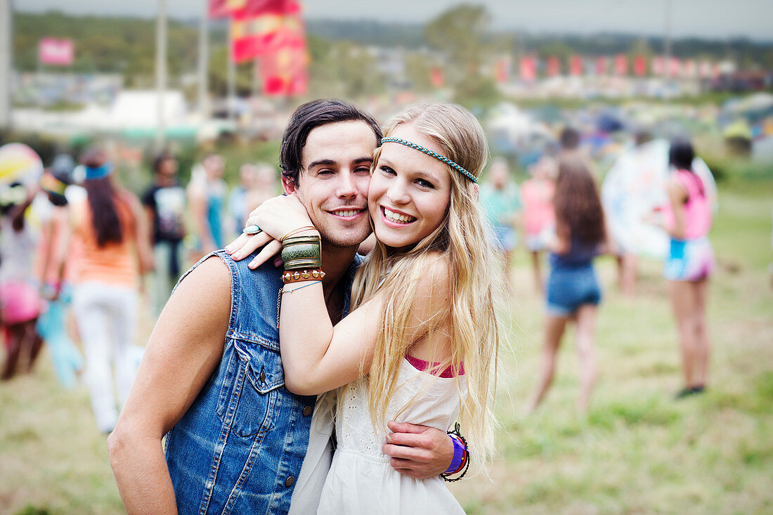 Couple hugging at music festival