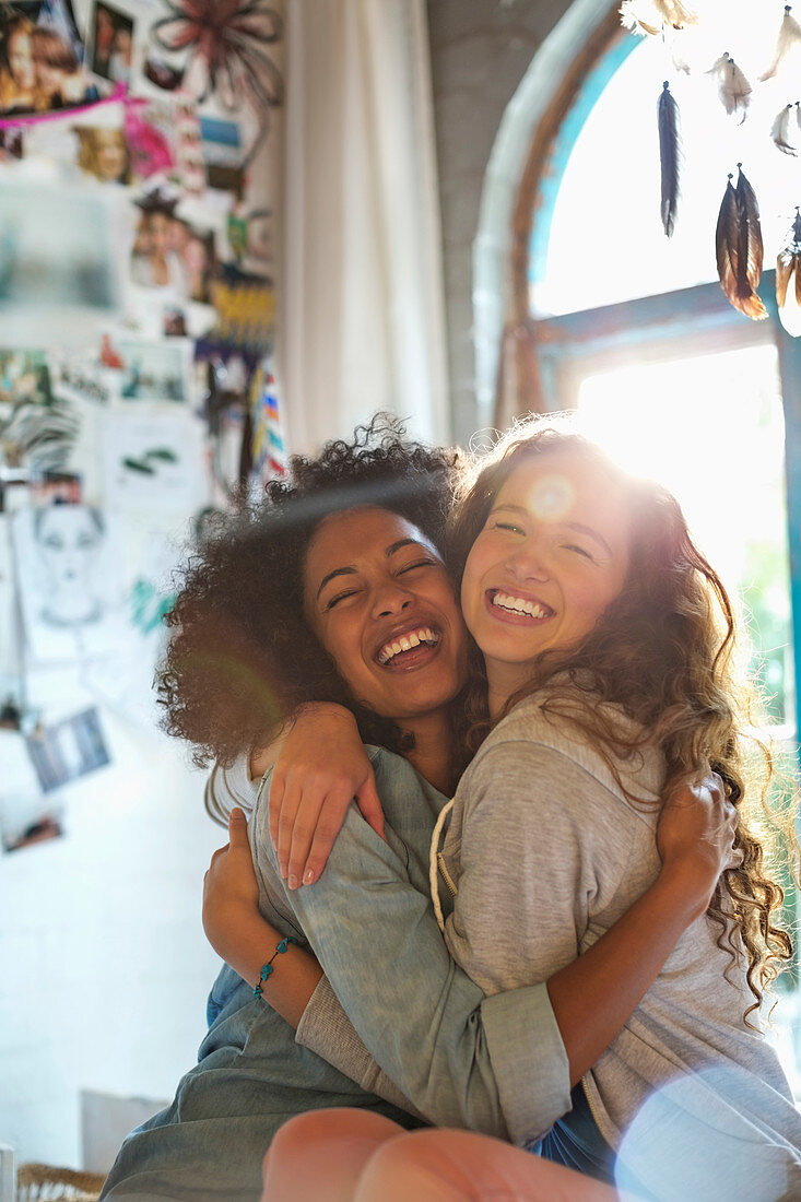 Women hugging in bedroom