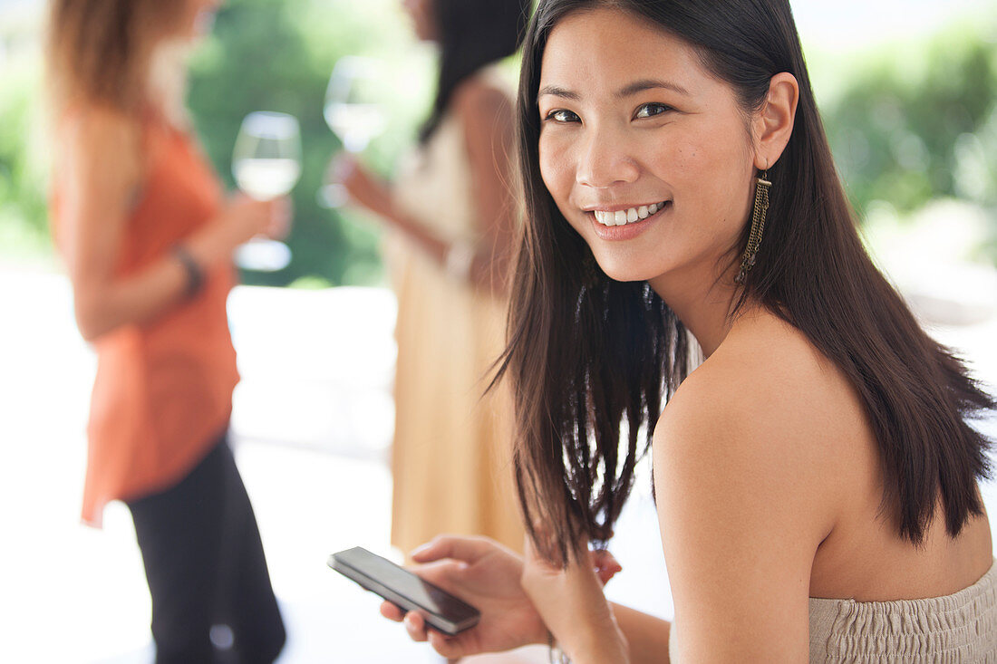 Smiling woman using cell phone