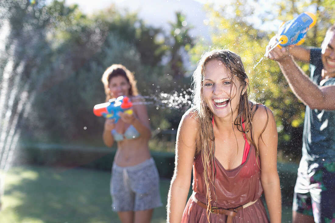 Friends playing with water guns