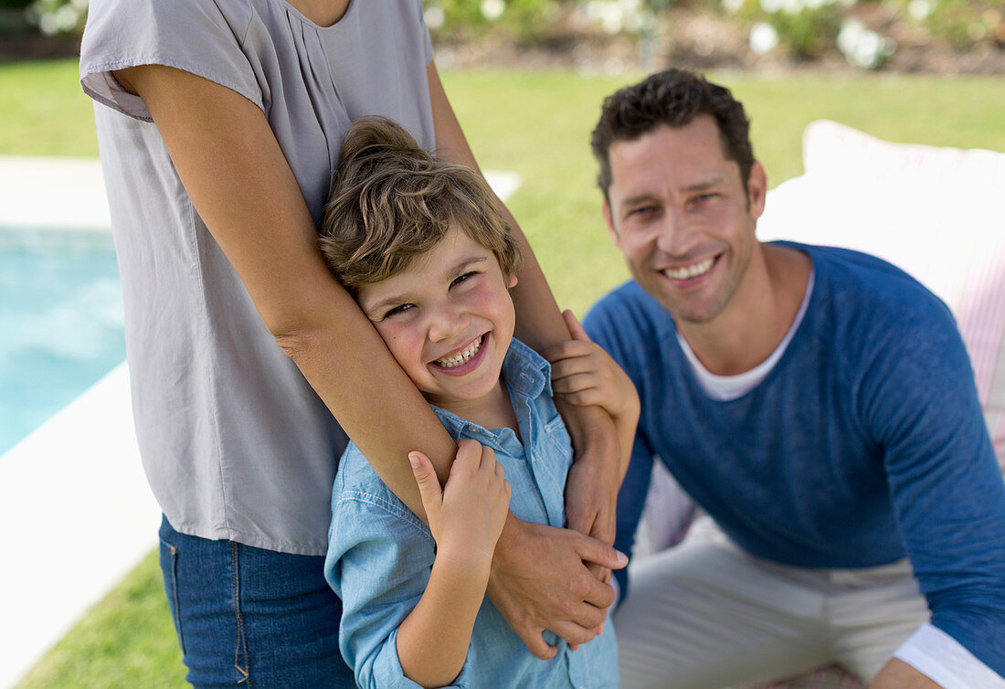 Family smiling in backyard