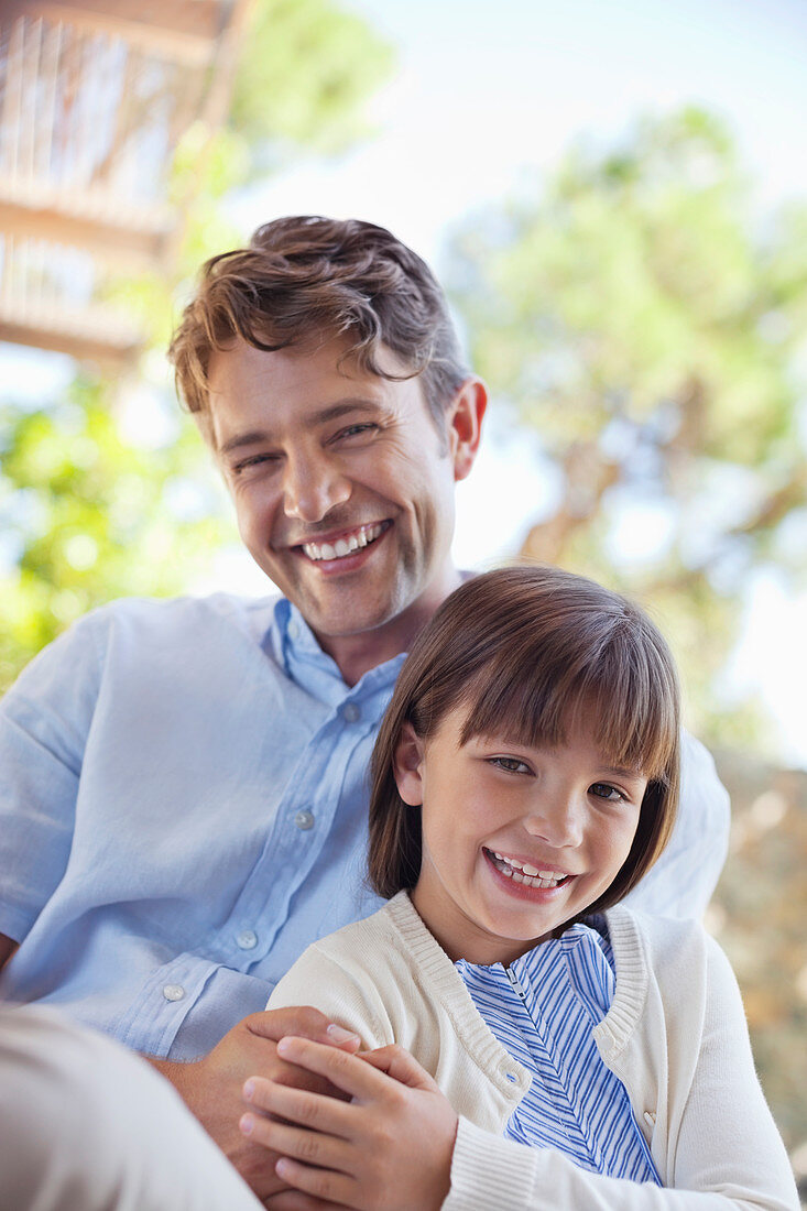 Father and daughter hugging outdoors