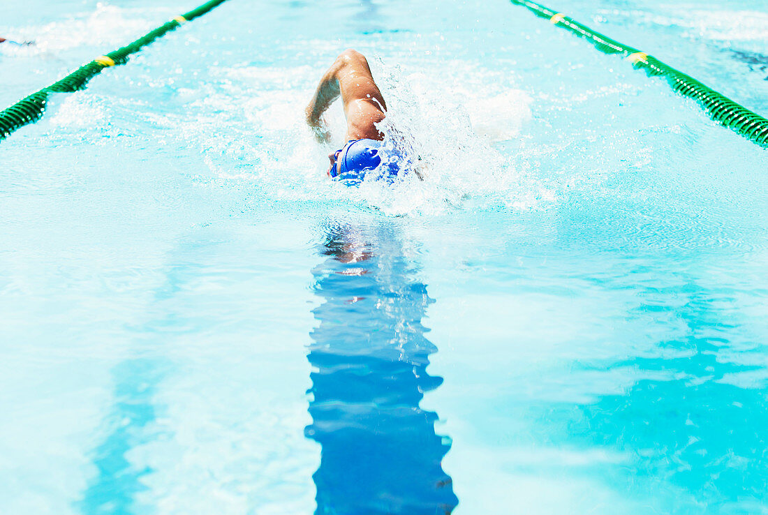 Swimmer racing in pool