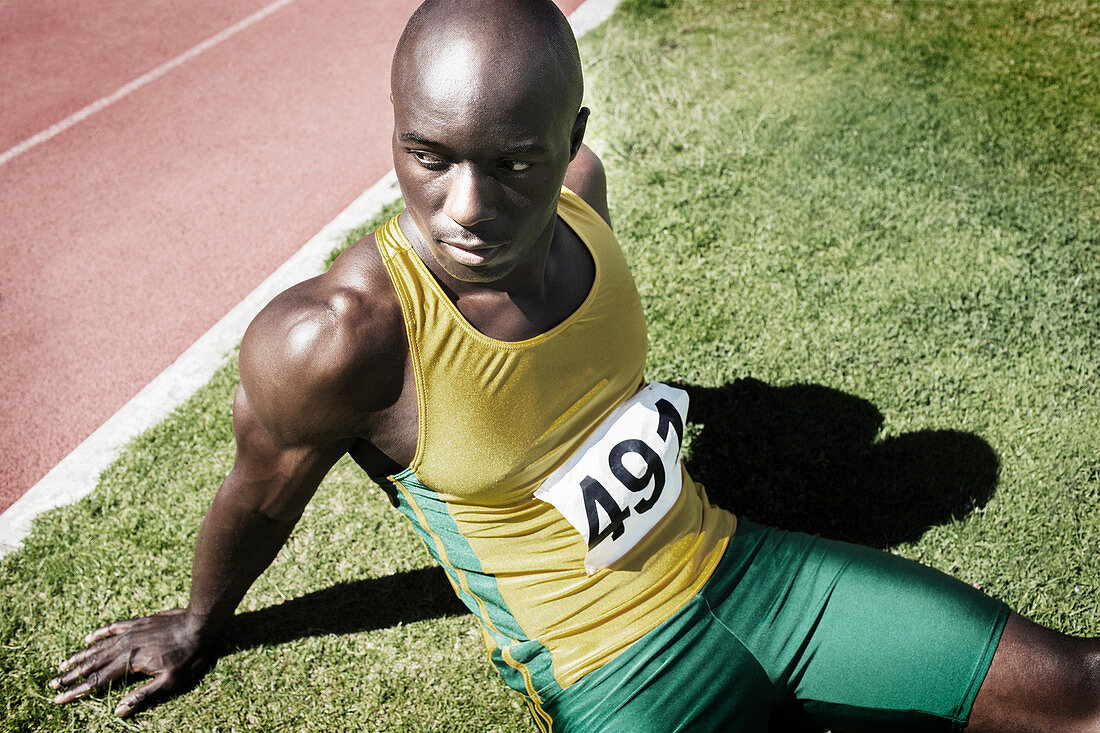 Athlete resting in grass