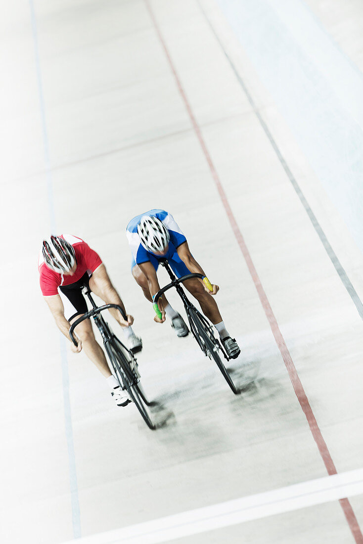 Track cyclists racing in velodrome