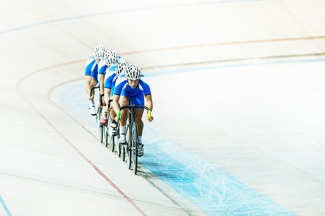 Track cycling team riding in velodrome