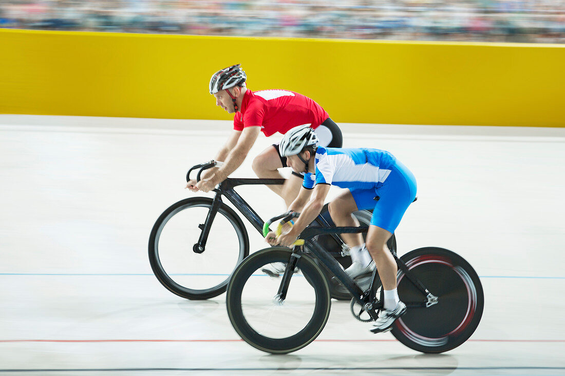 Track cyclists racing in velodrome