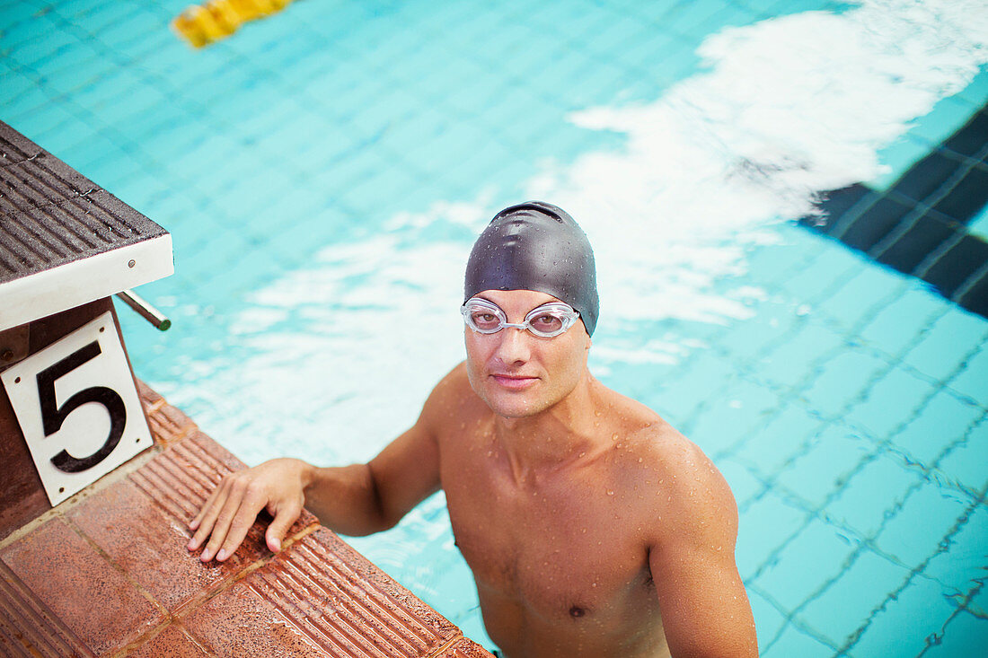 Swimmer standing at the edge of pool