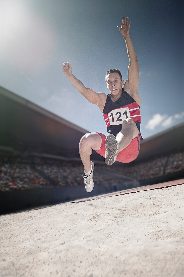 Long jumper above sand pit