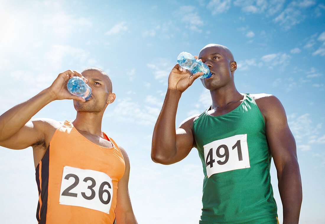 Runners drinking water on track