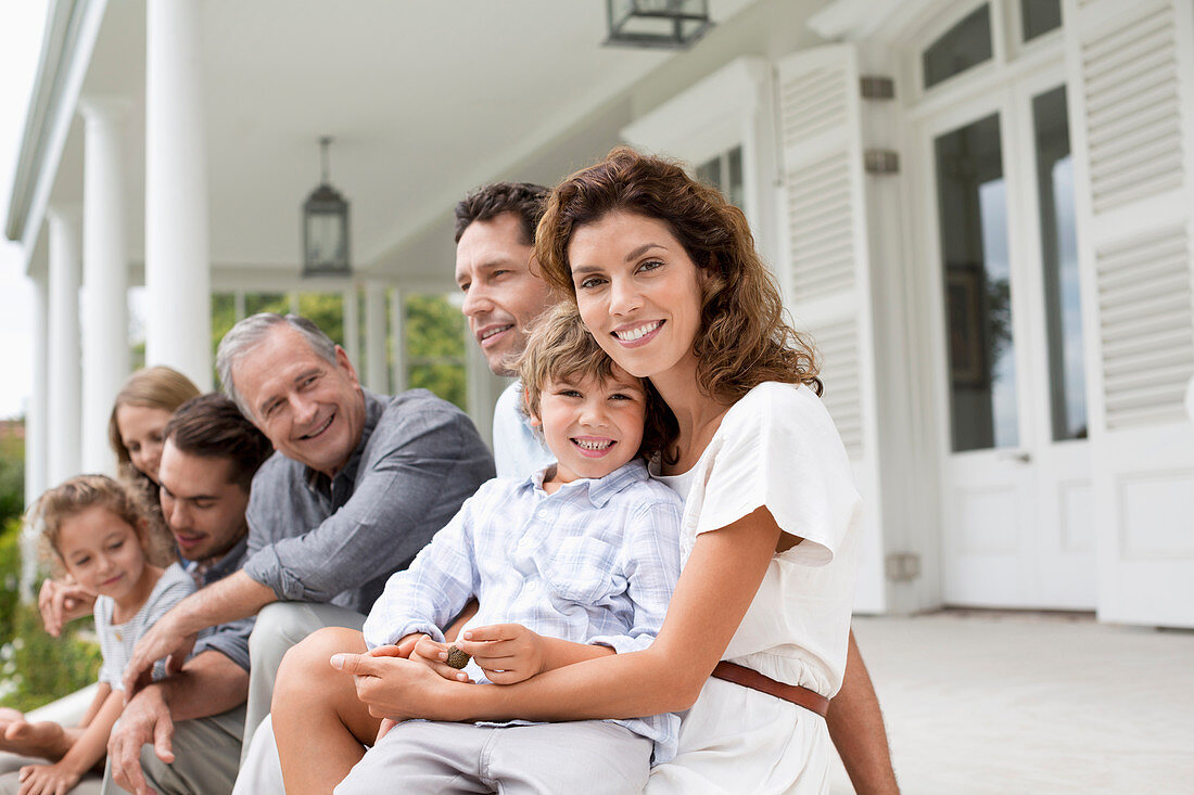 Family relaxing on porch together