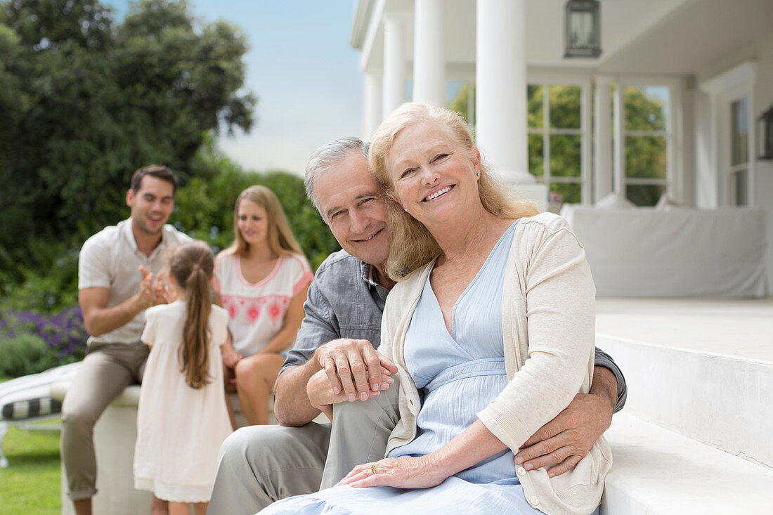 Older couple smiling on porch