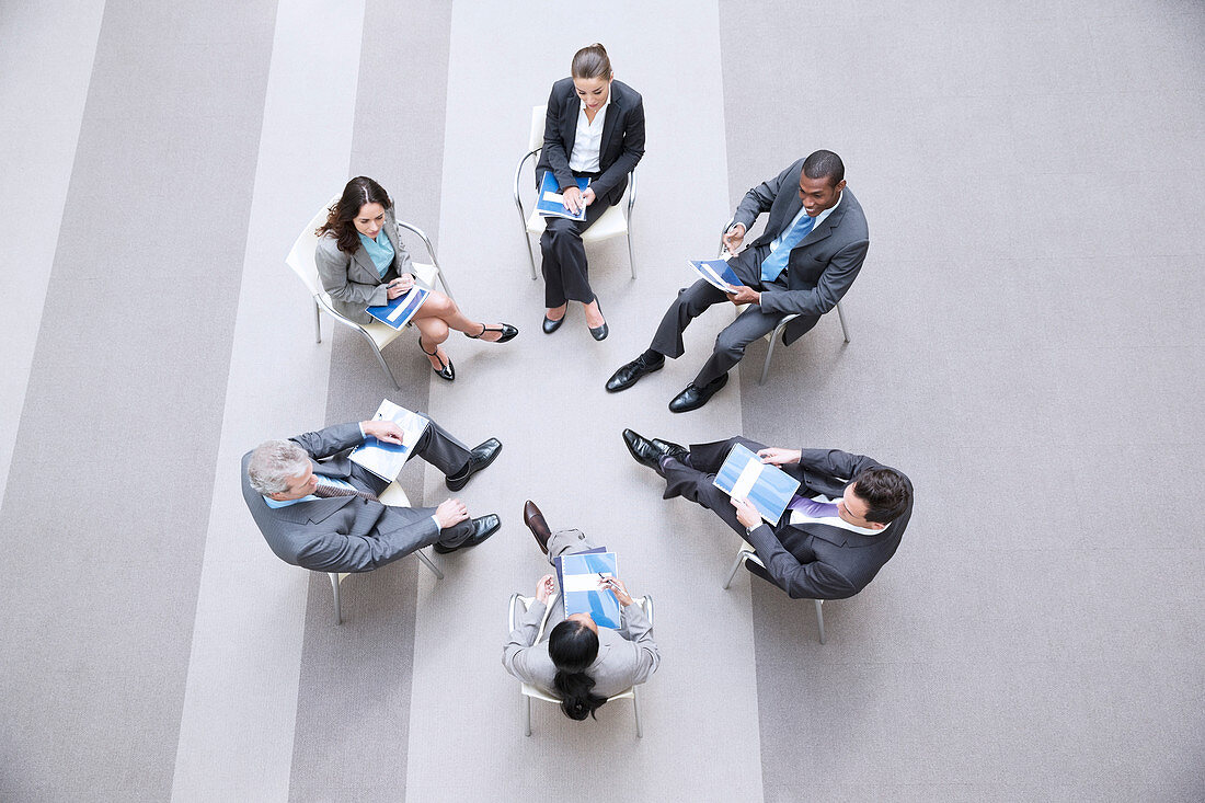 Business people sitting in circle