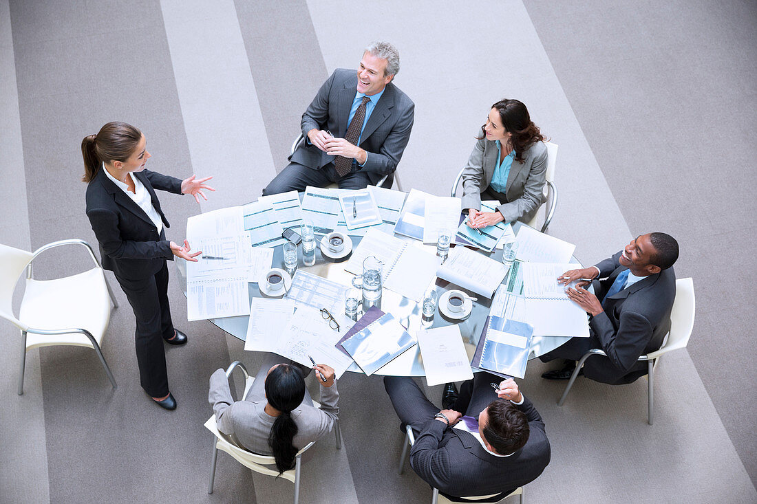 Gesturing businesswoman leading meeting