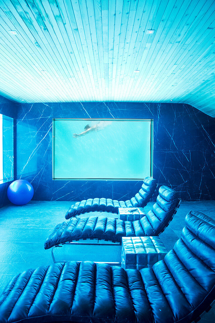 Room view of woman swimming underwater