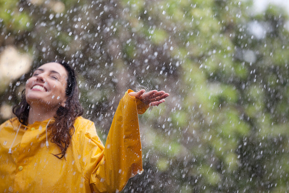 Happy woman standing in rain