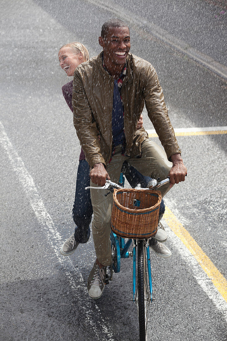 Happy couple riding bicycle