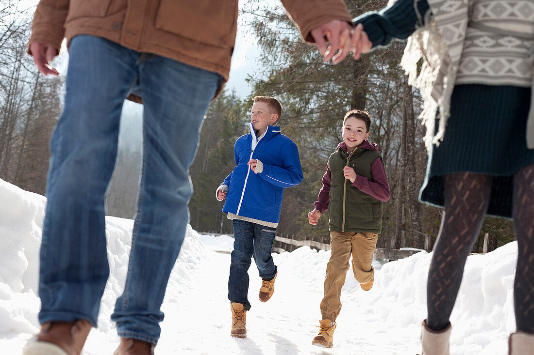 Boys running behind parents holding hands