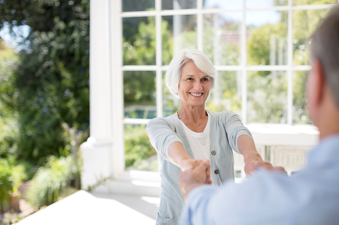 Senior couple dancing on patio