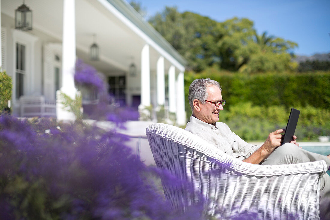 Senior man using digital tablet in garden