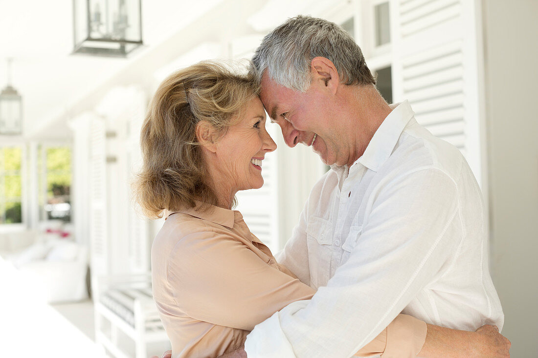 Senior couple hugging on patio