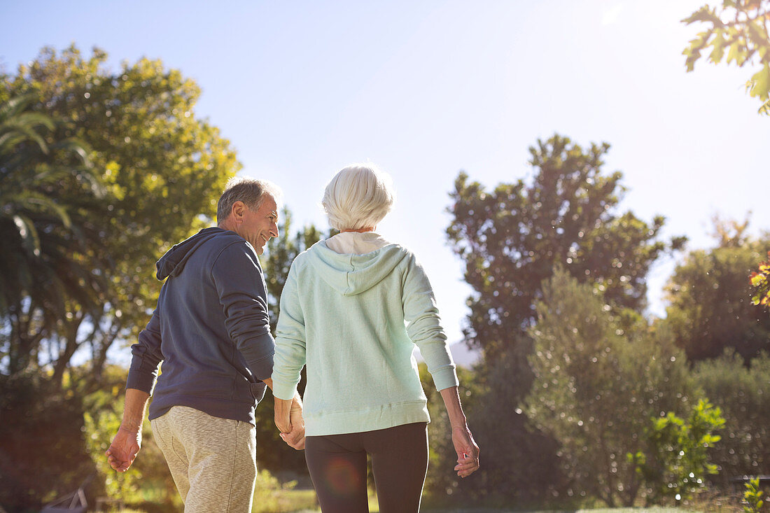 Senior couple holding hands and walking